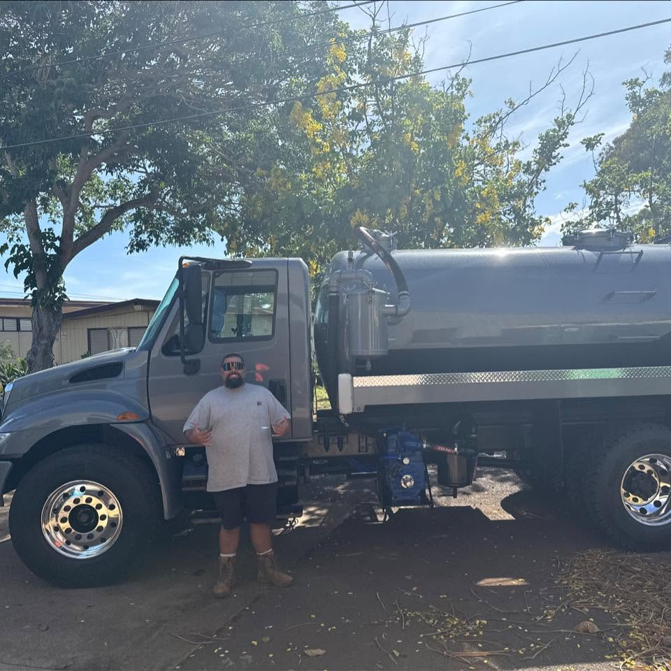 Klifton Gomes with the Unko Doo Doos septic service truck on Kauai